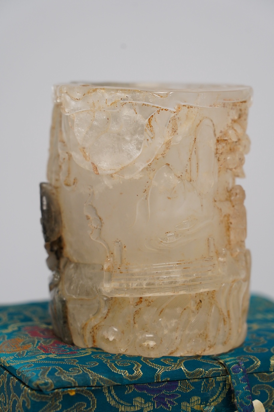 A Chinese quartz brushpot carved with figures before a landscape, cased, 14cm high. Condition - good